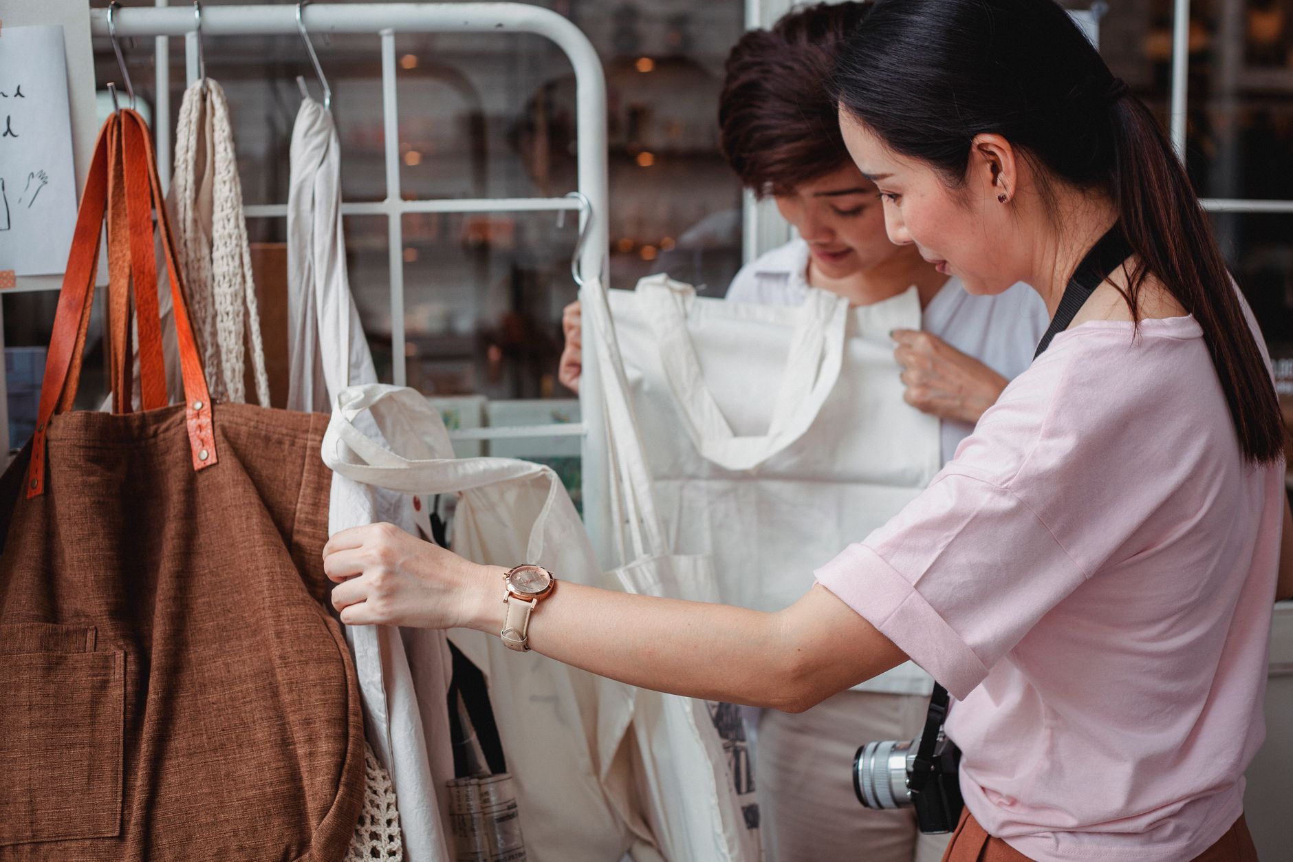 Customer choosing reusable eco-friendly bags at a shop