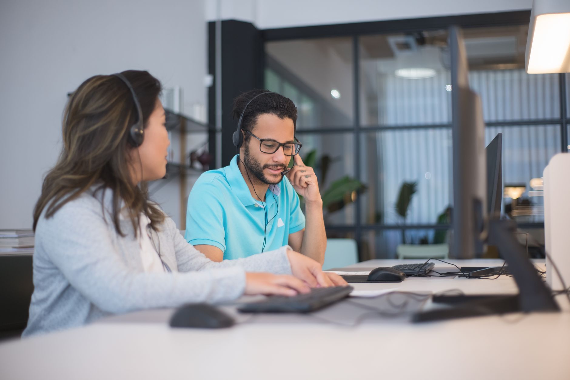 Telecom store employee helping a customer with their contract