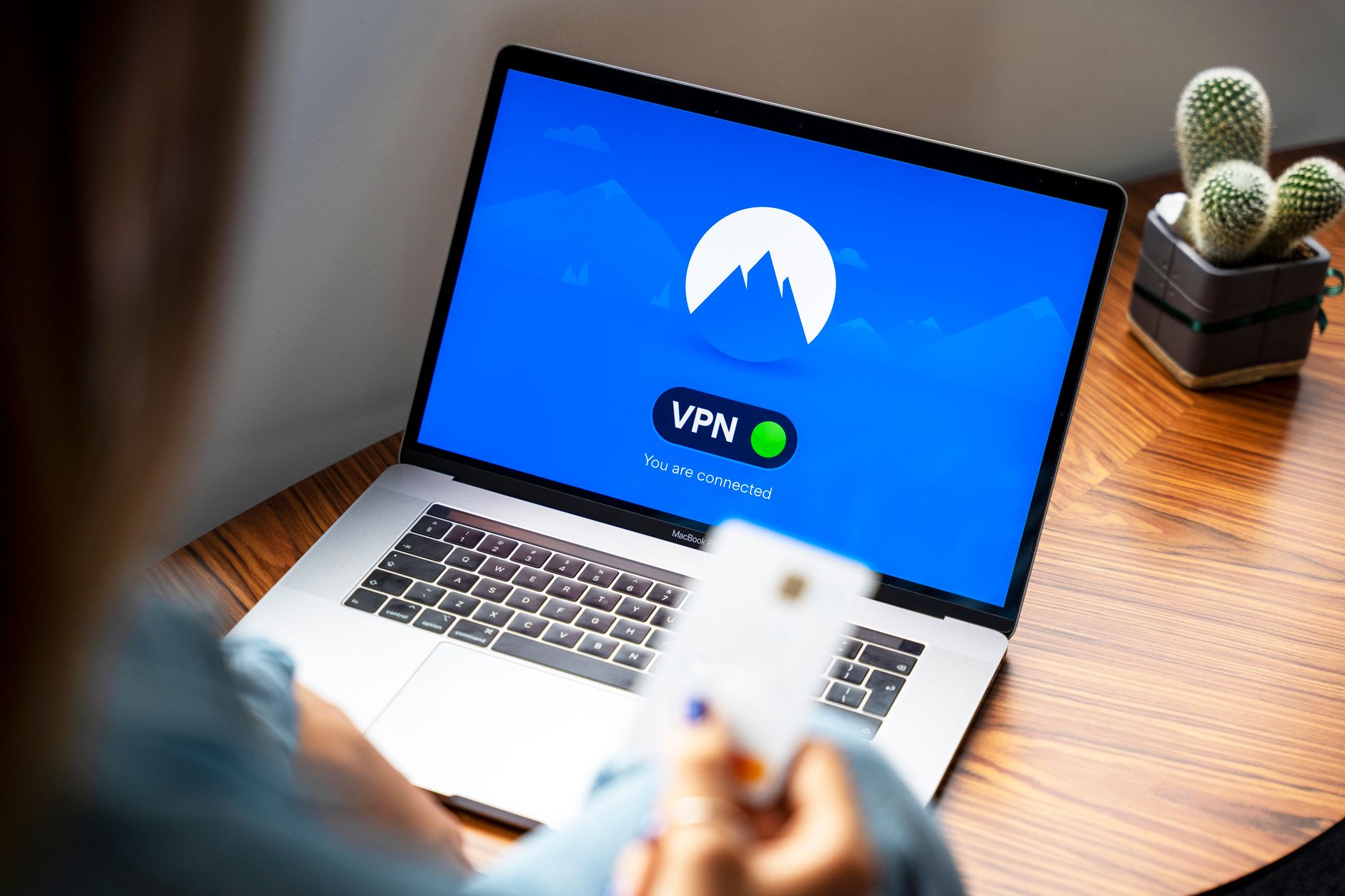 Laptop with an active VPN connection showing a security lock icon on the screen
